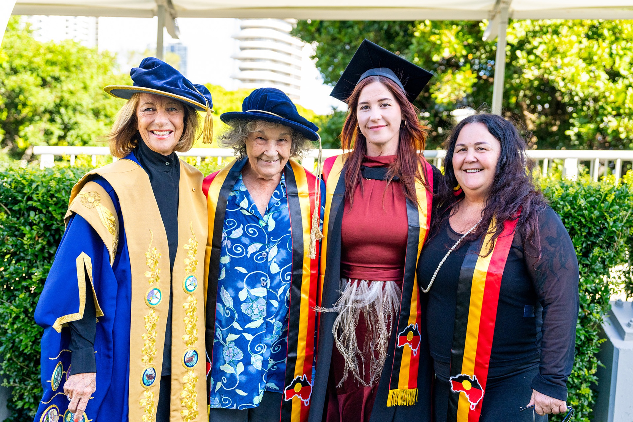four women standing in academic dress