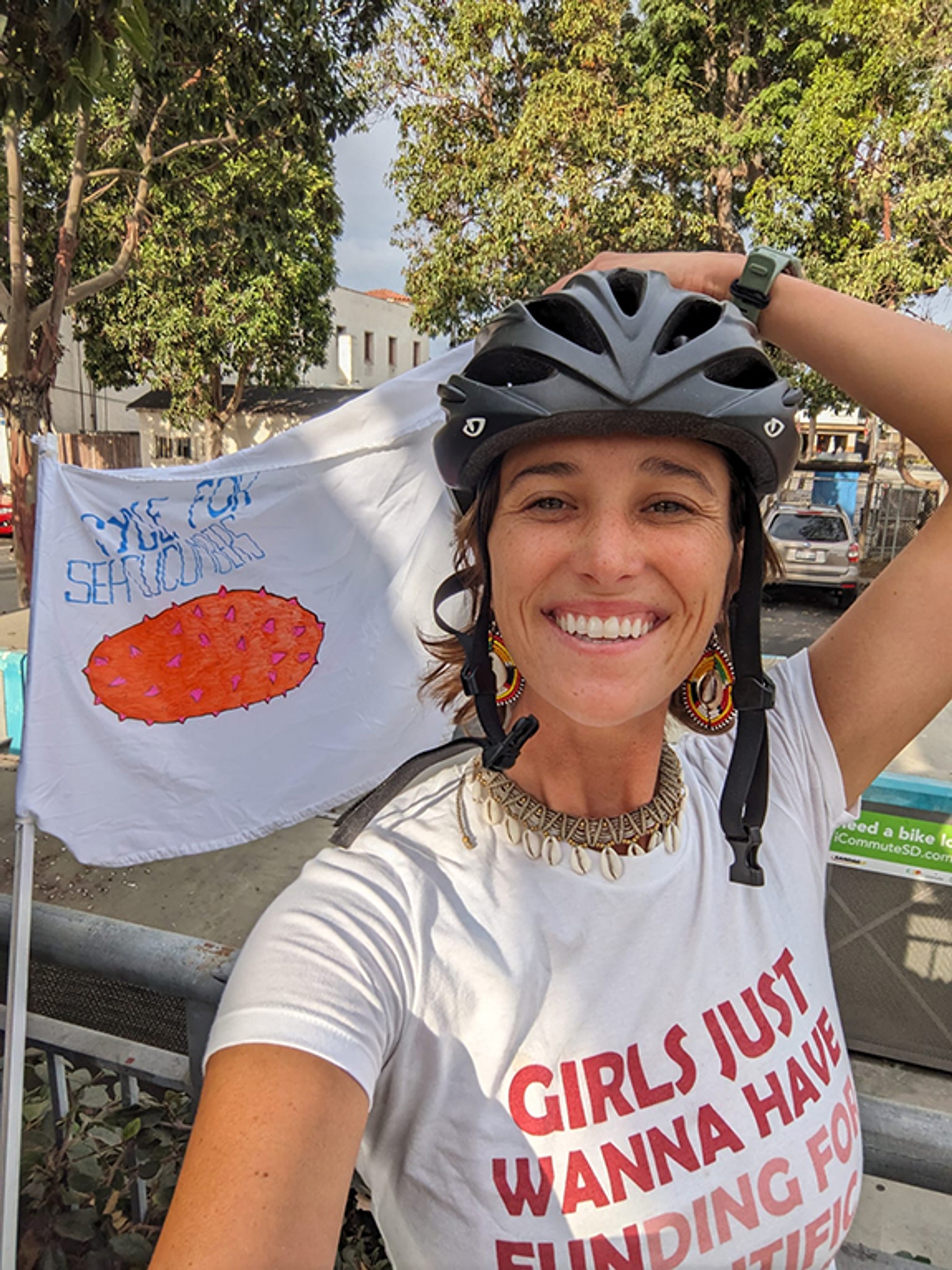A woman wearing a helmet on a bicycle