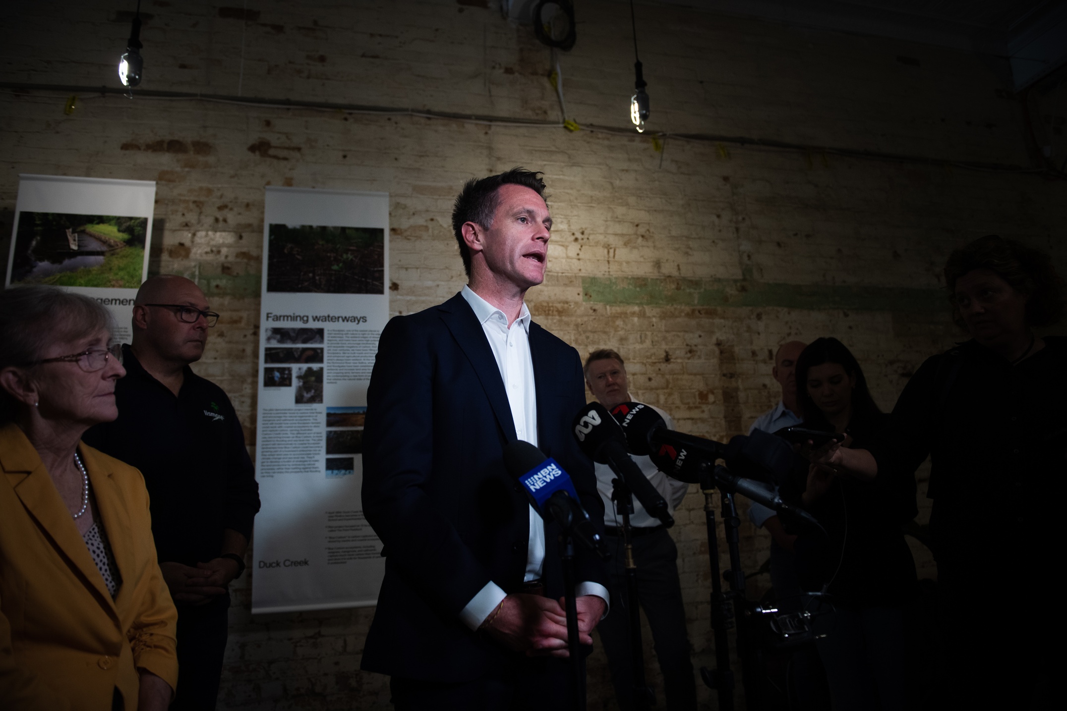 A man in a suit at a media conference