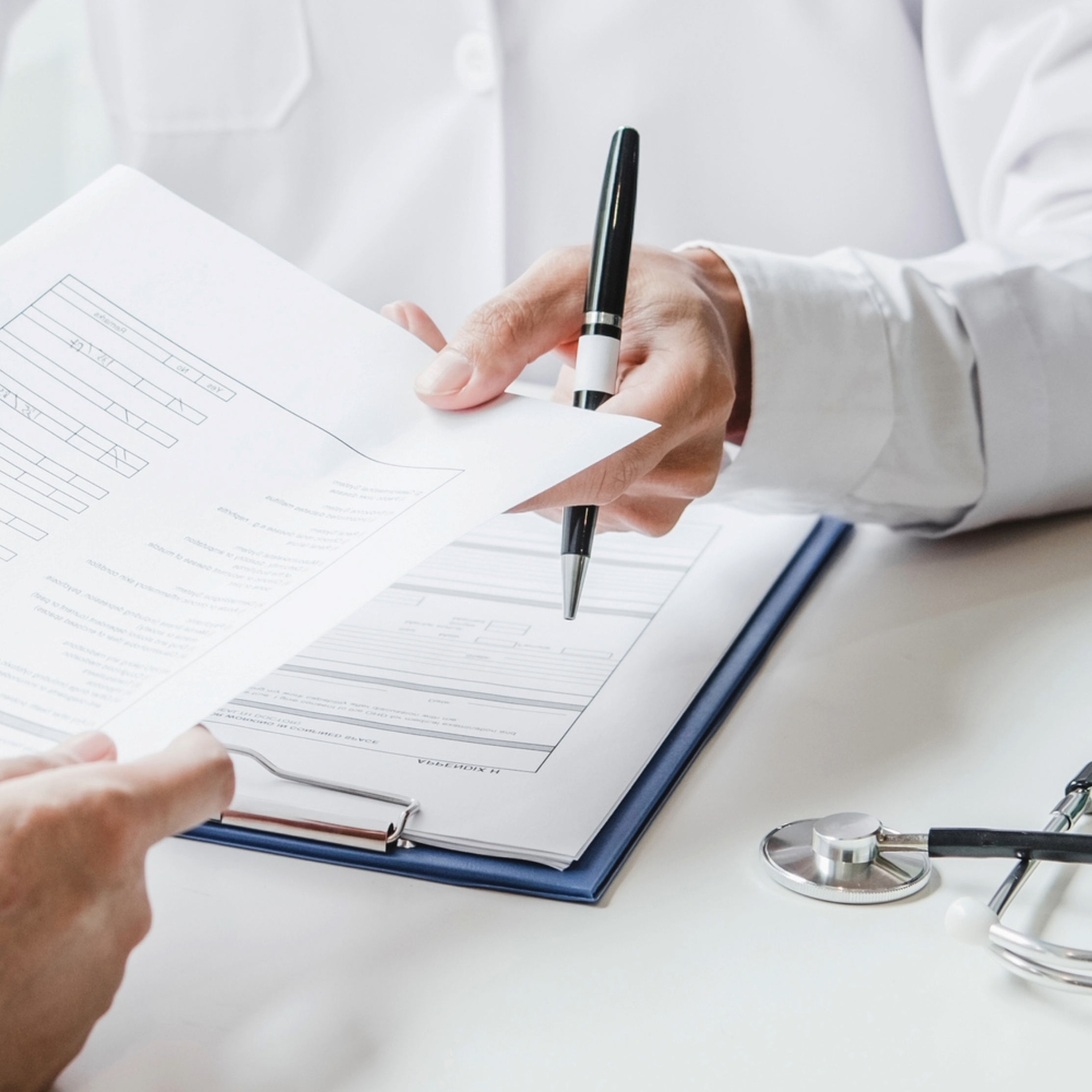 Hand holding a client form to a client