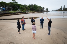 A group of people standing on a beach