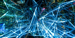 Image of blue lights connecting with a night city landscape
