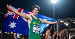 Man in green sports uniform holding Australian flag