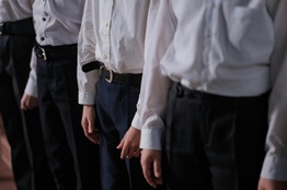 A row of students in shirt and trousers