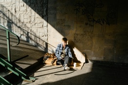 Homeless woman sitting on concrete floor
