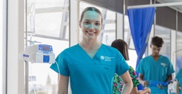 Female smiling at camera in scrubs