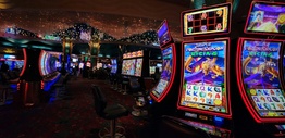 Casino room filled with lots of pokies