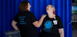 Two women in a hospital ward with PREDICT tshirts for delirium awareness