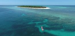 Two boats over the reef next to an island