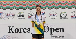 Student in athletic gear with medal
