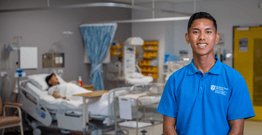 Nurse John Palencia faces camera in a hospital ward