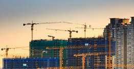 Skyline of cranes above building site