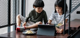 Two children using a digital tablet