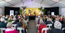 Crowd facing stage of panellists