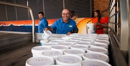 Person smiling in front of buckets