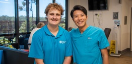 2 men in blue uniform shirts