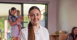 Woman smiling at camera with white collared shirt