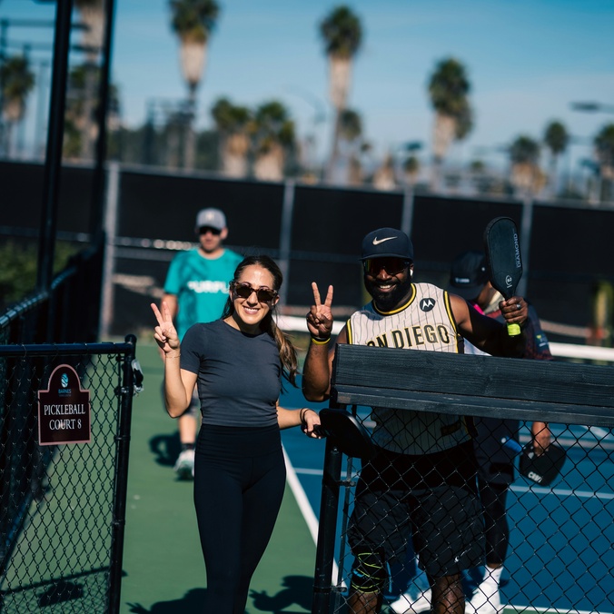 Students smiling as they leave the pickle ball court