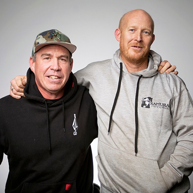 Two men in sloppy joes with arms wrapped around each other