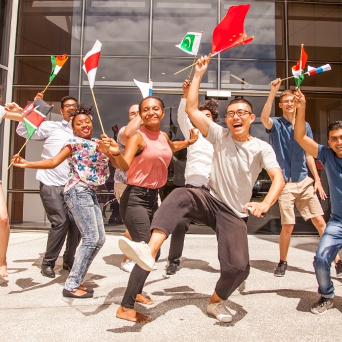Students dancing with international flags
