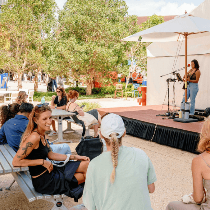 Students watching a musician