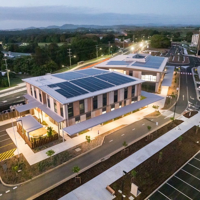 Aerial photograph of a hospital precinct, large illuminated buildings at dusk