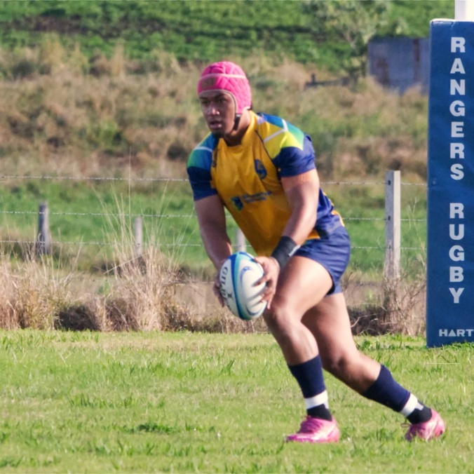 Man playing ruby about to kick the ball