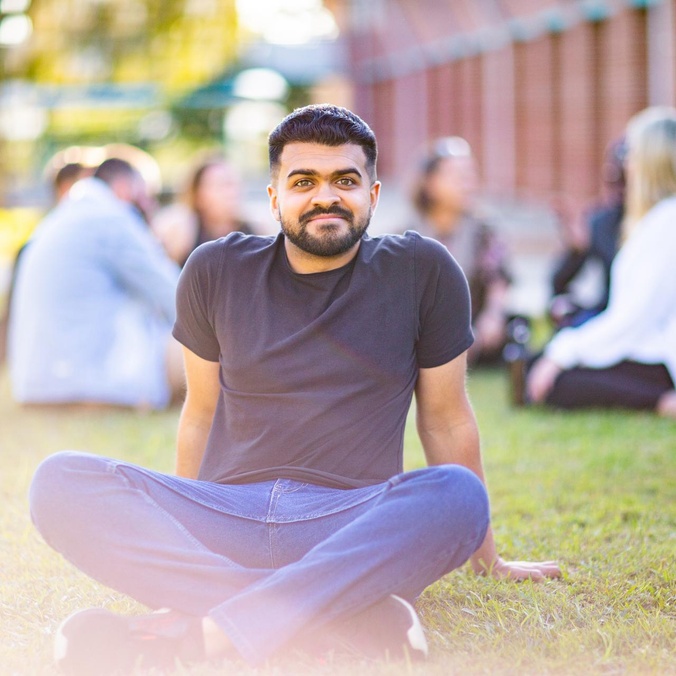 Coffs Harbour student sitting on grass