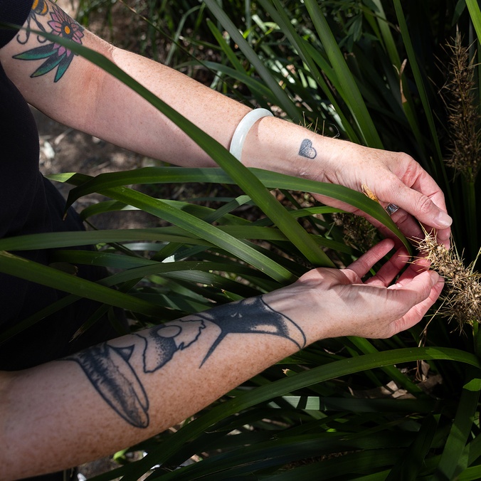Woman holding leafy plant in arms