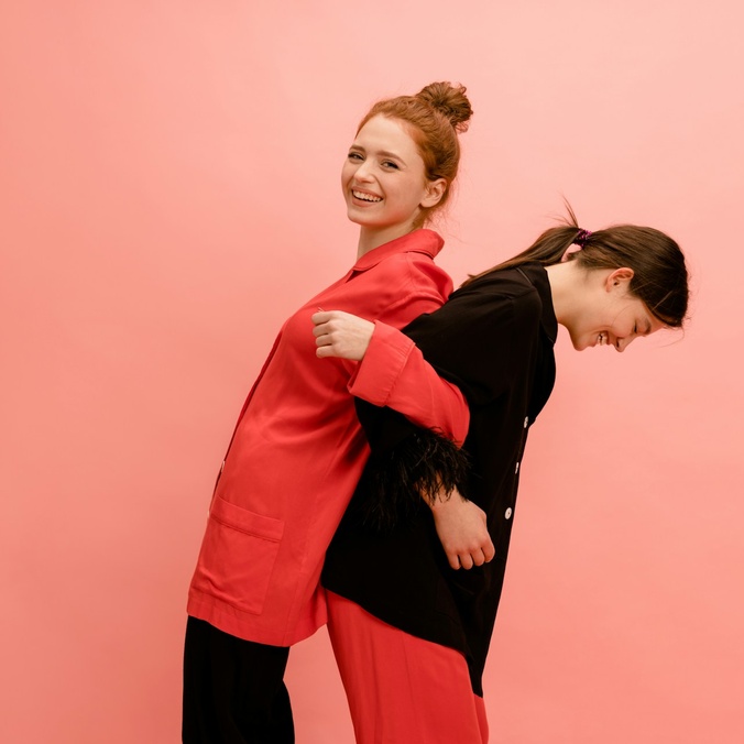 Two women linking arms