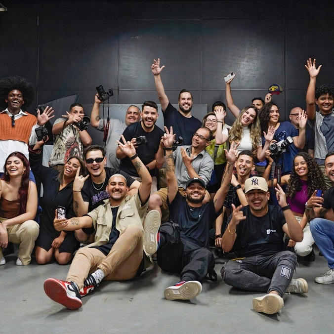 Large group of students cheering with hands in the air
