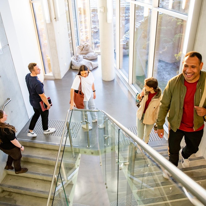 Students walking up a staircase on the Gold Coast campus