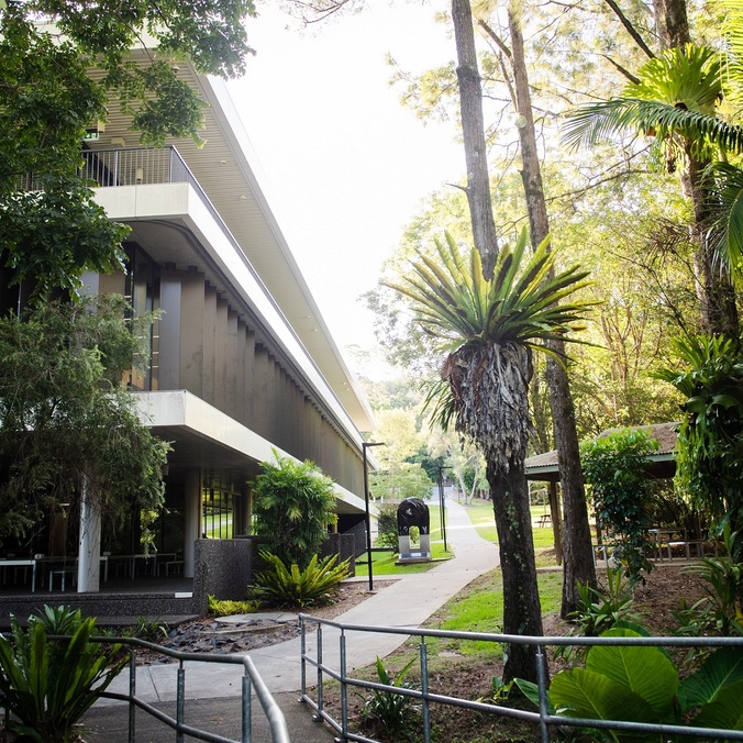 Corner of a modern building surrounded by rainforest