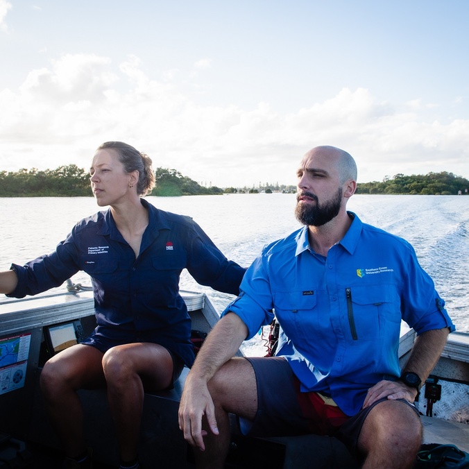 Two people on a boat on a river