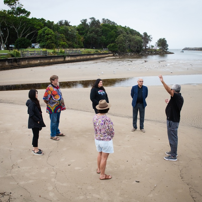 A group of people standing on a beach