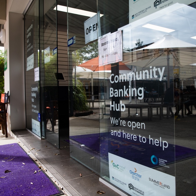 a shopfront with a sign reading community banking hub