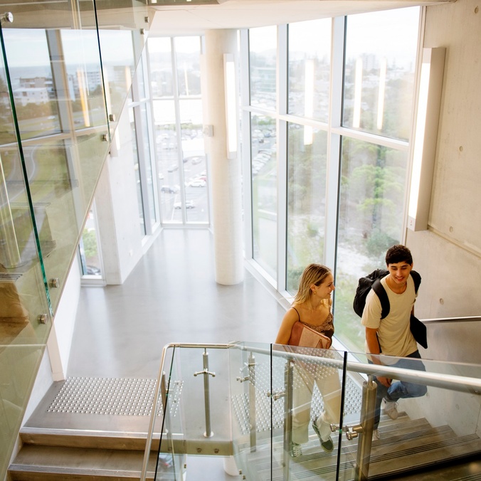 Two students climbing a staircase at the Gold Coast campus