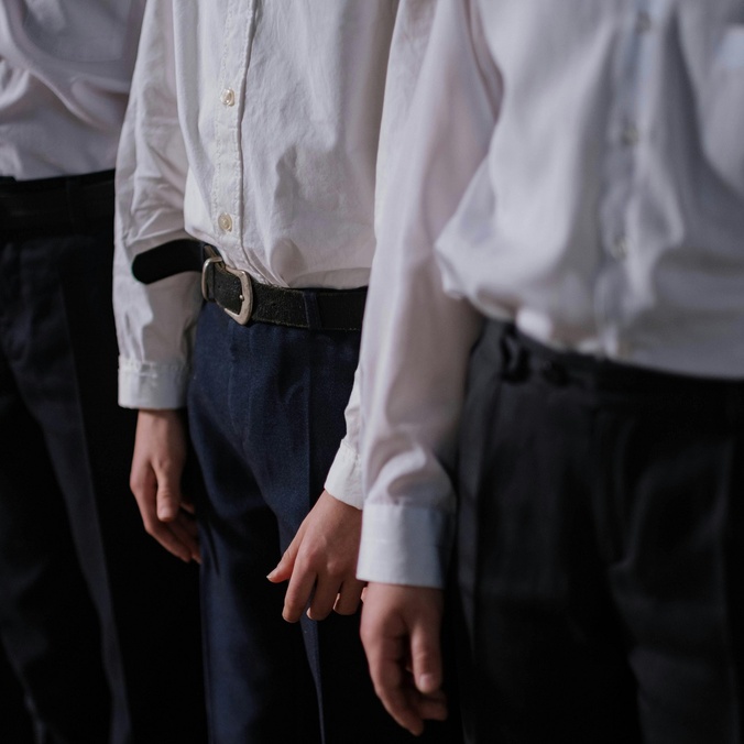 A row of students in shirt and trousers