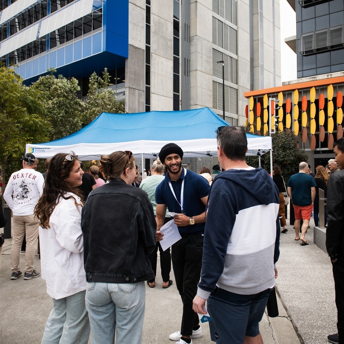 Student ambassador greeting visitors at Gold Coast Open Day