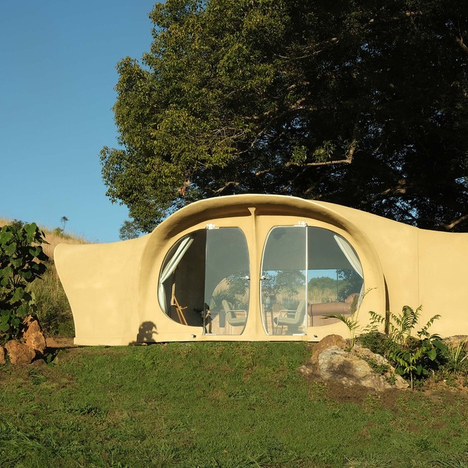 An organic shaped tiny house in a natural setting