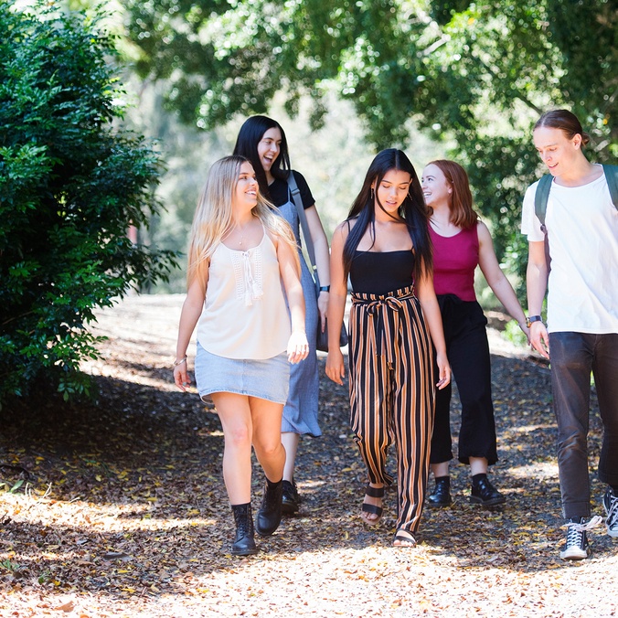 Students walking along path talking