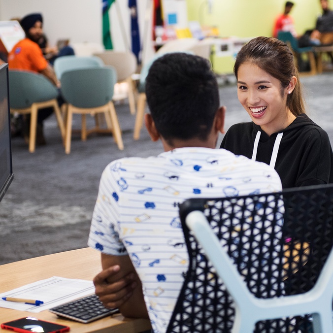 two international students sitting down