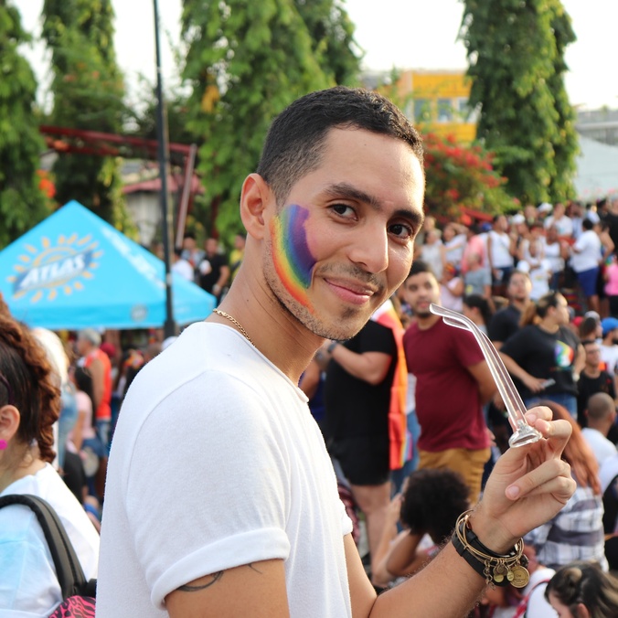 Person with rainbow painted on cheek