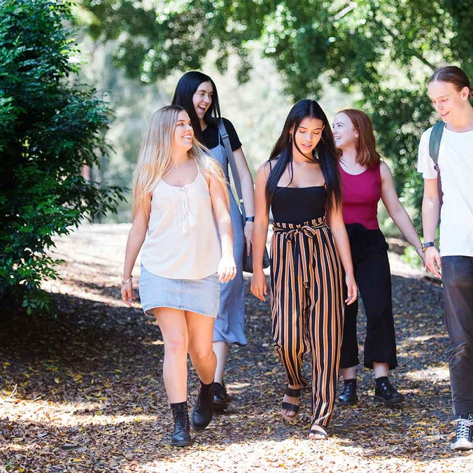 Students walking along path talking