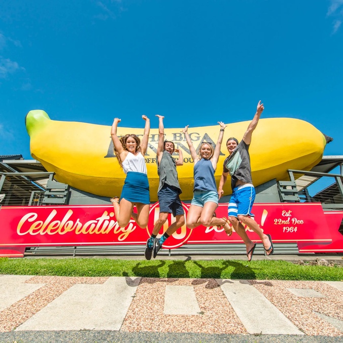 Four people jumping outside the Big Banana fun park at Coffs Harbour