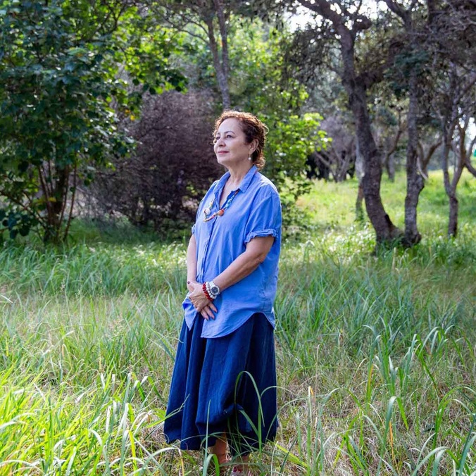 Nicole Tujague PhD stands in nature