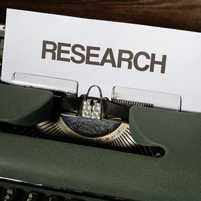 research sign on typewriter