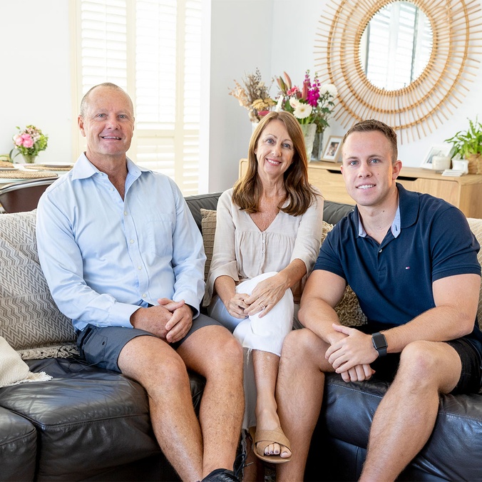 parents and son sitting on a couch