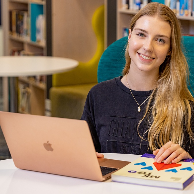 student with laptop open