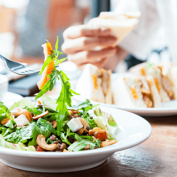 People eating sandwiches and salads